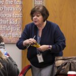 Robin Brown handing out pencils.