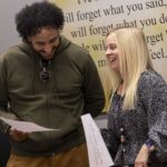 Two E2CCB employees laugh as they talk.