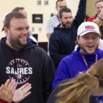 A group of teachers smile as they celebrate.